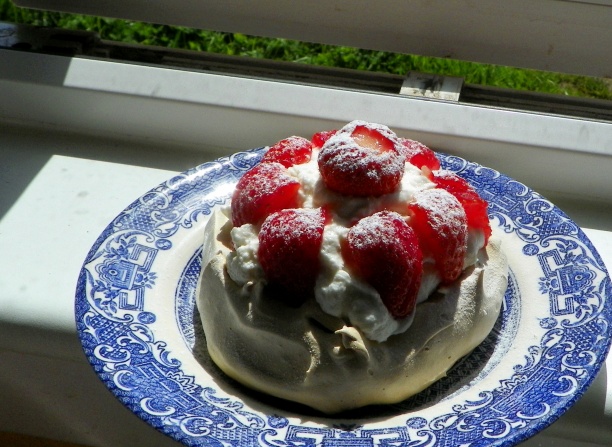Strawberries and vanilla cream on a meringue nest